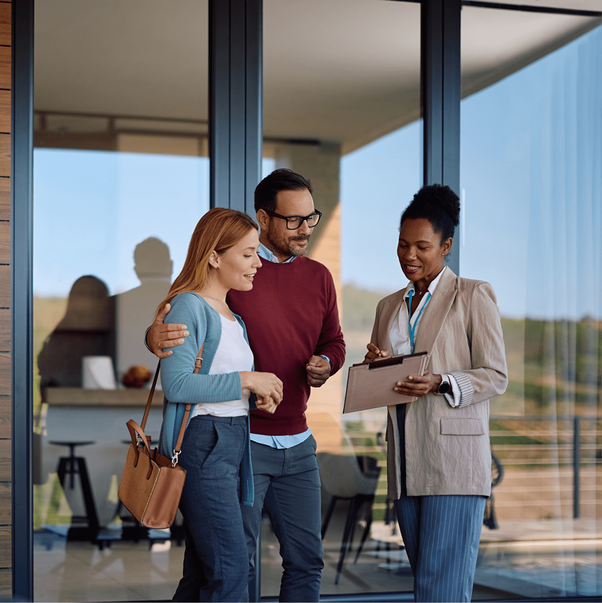 People reviewing documents outside modern building
