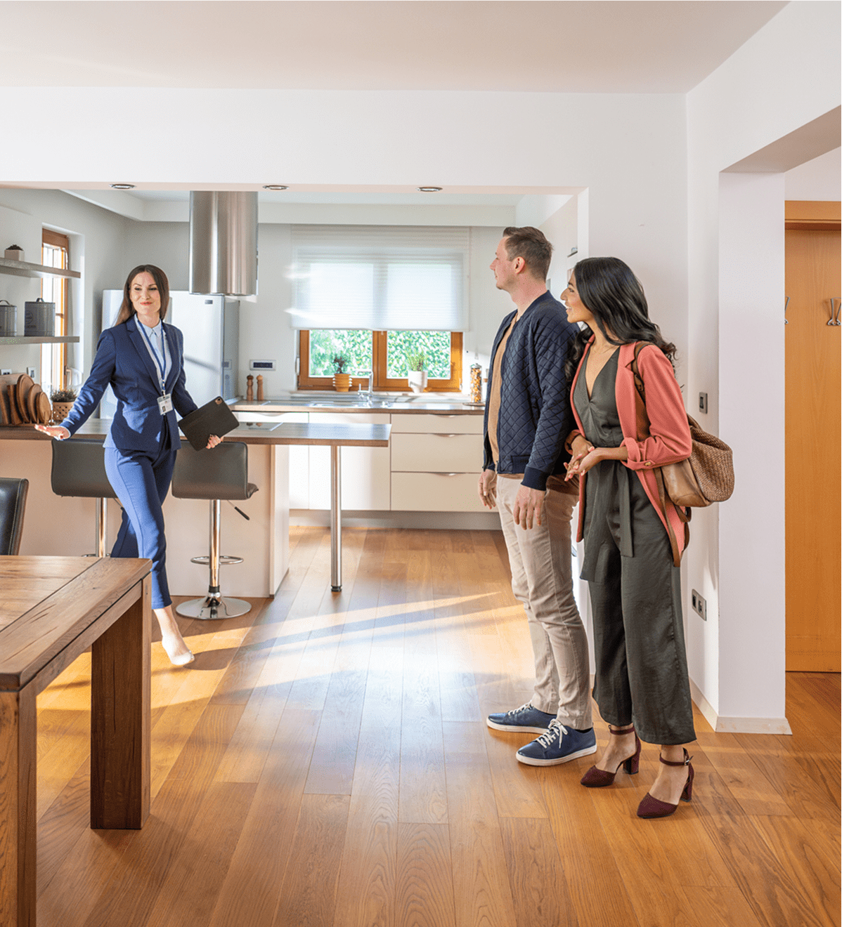 Real estate agent showing modern kitchen